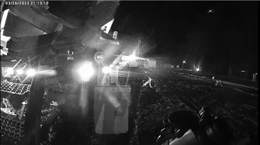 This still image from body cam video shows Joplin SWAT members preparing to enter the camper where Clessie and Eli Crawford died. The toddler’s big wheel is in the yard with the Kansas Highway Patrol helicopter above.