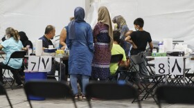 Afghan refugees are processed at Fort Bliss' Doña Ana Village where they are being housed, in New Mexico, Friday, Sept. 10, 2021. The Biden administration provided the first public look inside the U.S. military base where Afghans airlifted out of Afghanistan are screened, amid questions about how the government is caring for the refugees and vetting them.