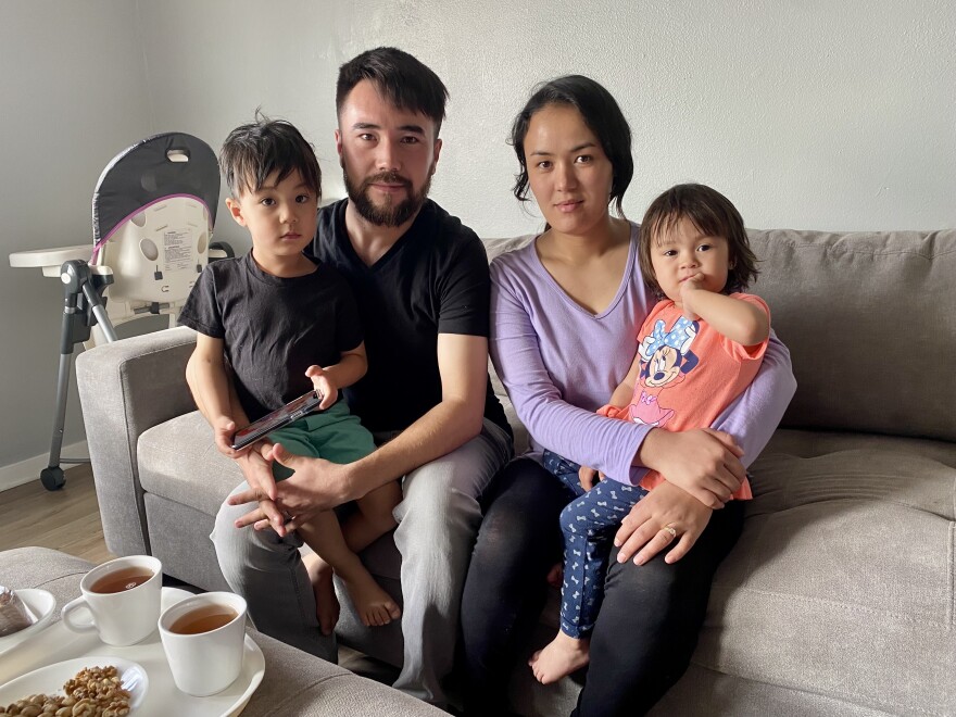  Reza Akrami sits with his wife, Firuza Haidari, and their two children in their new home in Sergeant Bluff, Iowa. They are among hundreds of Afghan refugees who have resettled into the state since August.