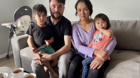  Reza Akrami sits with his wife, Firuza Haidari, and their two children in their new home in Sergeant Bluff, Iowa. They are among hundreds of Afghan refugees who have resettled into the state since August.