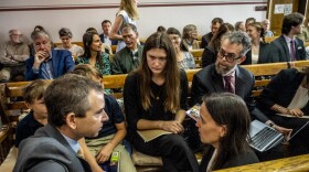 Lead claimant Rikki Held, 22, confers with members of Our Children's Trust legal team before the start of the nation's first youth climate change trial at Montana's First Judicial District Court on June 12, 2023 in Helena, Montana.