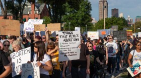 Hundreds of protesters walk up Grand Ave. toward the governor's residence in Des Moines Friday evening to protest the U.S. Supreme Court's ruling overturning Roe v. Wade.