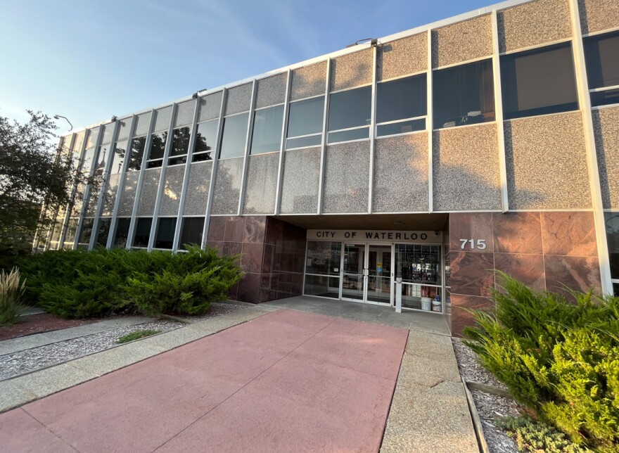 Waterloo City Hall's red marble and stone walkway at sunset.