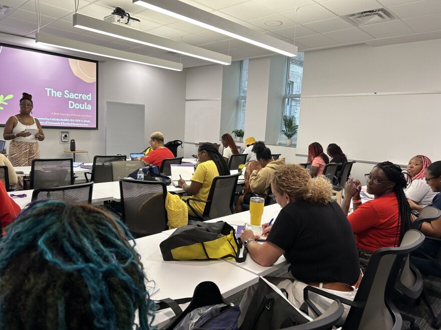 Mayelin Escobar sits in the back row of the doula-training class led by Lakisha Reddit in St. Louis on July 11, 2023. She has since graduated with her doula certificate from Virtuously B’Earthed Doula Services.