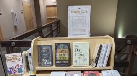 Books sit on a bookshelf in a library