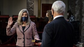 Vice President Mike Pence administers the oath of office to Sen. Joni Ernst, R-Iowa, left, joined by her daughter Libby Ernst, during a reenactment ceremony in the Old Senate Chamber at the Capitol in Washington, Sunday, Jan. 3, 2021.