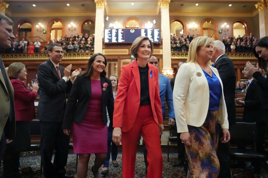 Gov. Kim Reynolds is escorted into the Iowa House of Representatives to give the annual Condition of the State address at the Iowa State Capitol on Tuesday, Jan. 9.