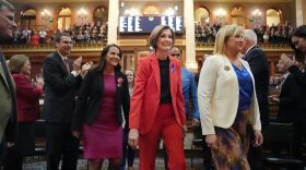 Gov. Kim Reynolds is escorted into the Iowa House of Representatives to give the annual Condition of the State address at the Iowa State Capitol on Tuesday, Jan. 9.