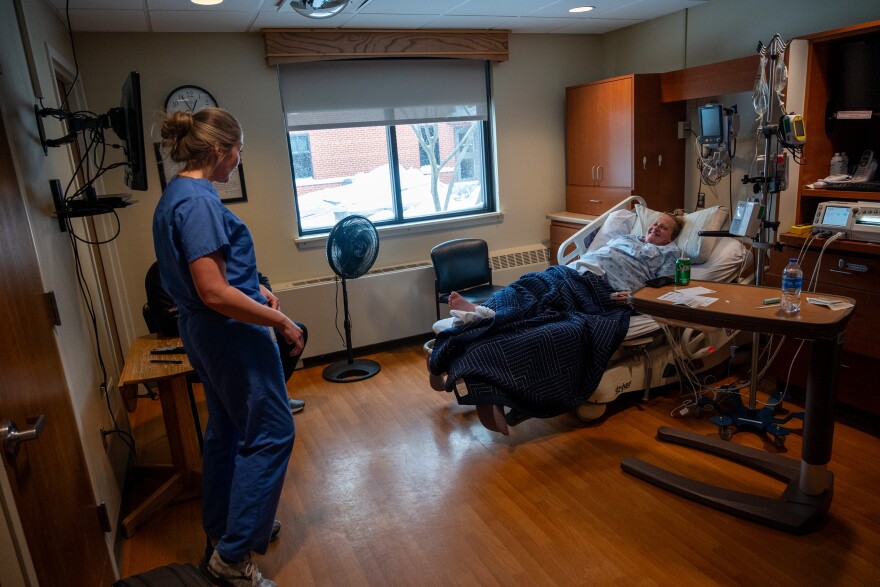 Dr. Emily Hill checks on her patient Karinne Tudor, who is in labor with her second child at Iowa Specialty Hospital in Clarion, Iowa.