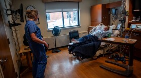 Dr. Emily Hill checks on her patient Karinne Tudor, who is in labor with her second child at Iowa Specialty Hospital in Clarion, Iowa.