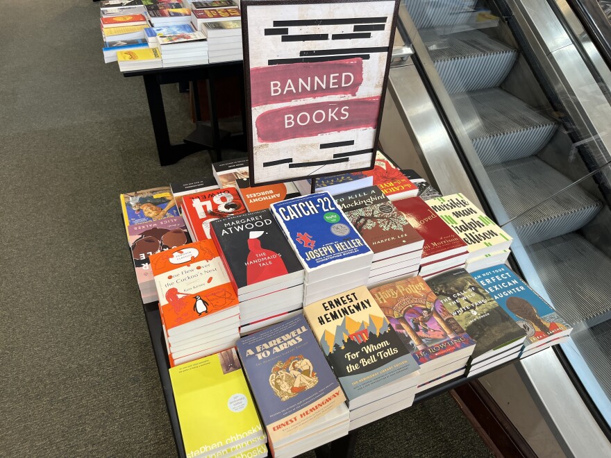 A pile of banned books at a Barnes and Noble. State education officials are offering details about how they’ll enforce a ban on sexually graphic books at Iowa schools.