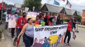 Advocates with the Fund Excluded Workers Coalition march towards Mercer Park in Iowa City on August 11, 2021. They're calling on local governments to allocate federal coronavirus aid to undocumented immigrants and low wage workers.