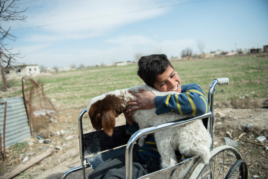 Azzam, 12, lost his leg when a bomb hit the building where he was sheltering with his family in Syria. They now live in a rural area outside of Damascus, where he finds happiness and peace in caring for the farm animals after school. The photo is from Feb. 21, 2022.