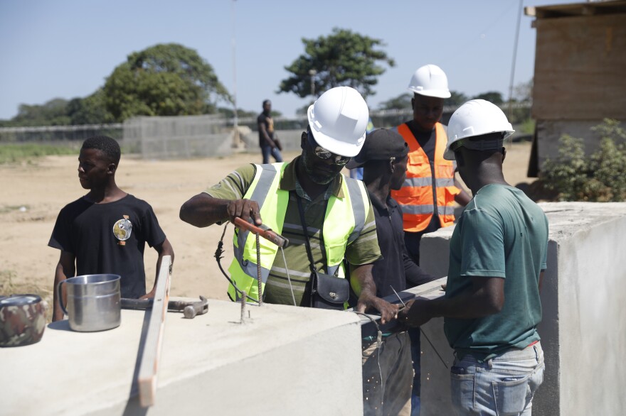 Construction workers are in finishing the canal project in the border city of Ouanaminthe, Haiti. Once completed, the nearby farming community hopes to benefit from the canal's water, aiding in the cultivation and yield of their crops.