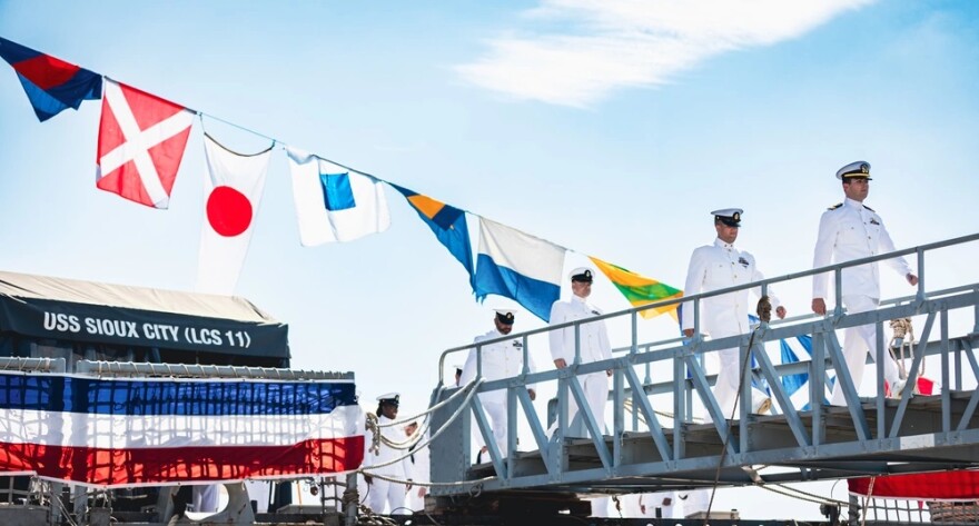 Sailors assigned to the USS Sioux City exit the ship for the final time during a decommissioning ceremony at Naval Station Mayport, on Aug. 14, 2023.