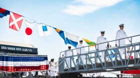 Sailors assigned to the USS Sioux City exit the ship for the final time during a decommissioning ceremony at Naval Station Mayport, on Aug. 14, 2023.