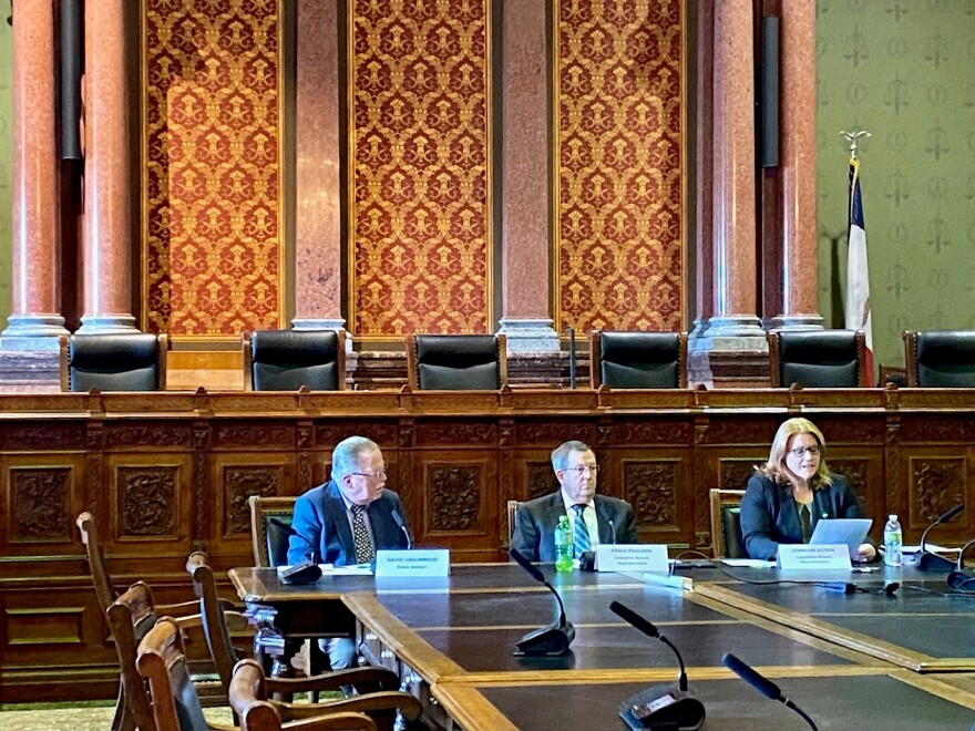 the three members of iowa's revenue estimating conference meet in the state capitol