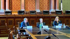 the three members of iowa's revenue estimating conference meet in the state capitol