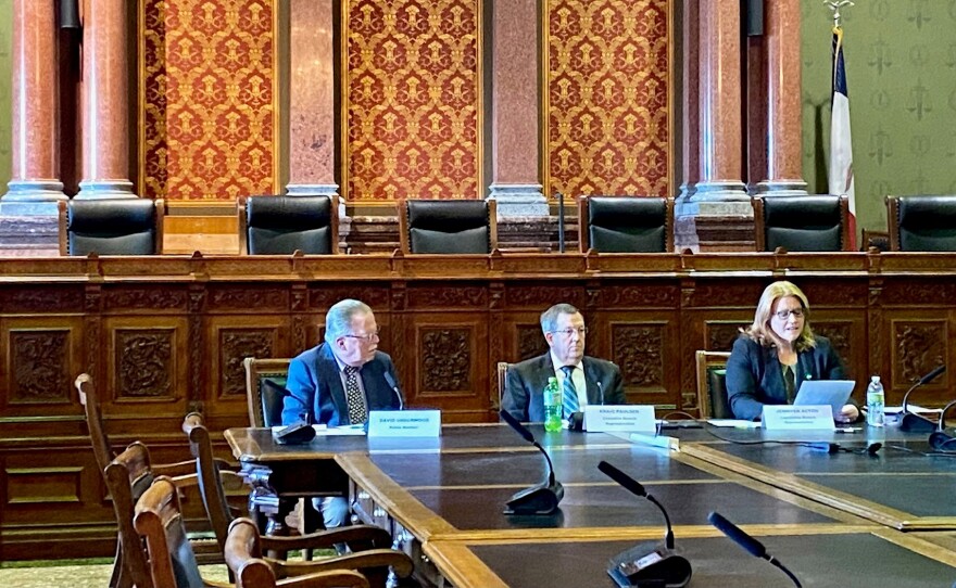 the three members of iowa's revenue estimating conference meet in the state capitol