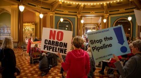 More than 100 farmers gathered in the rotunda of the Iowa Capitol in Des Moines to protest three carbon pipelines proposed in Iowa.