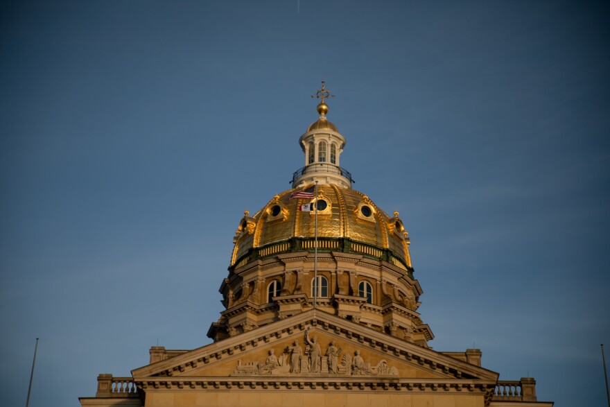 Gold dome of Iowa capitol against a gray-blue sky