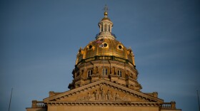 Gold dome of Iowa capitol against a gray-blue sky