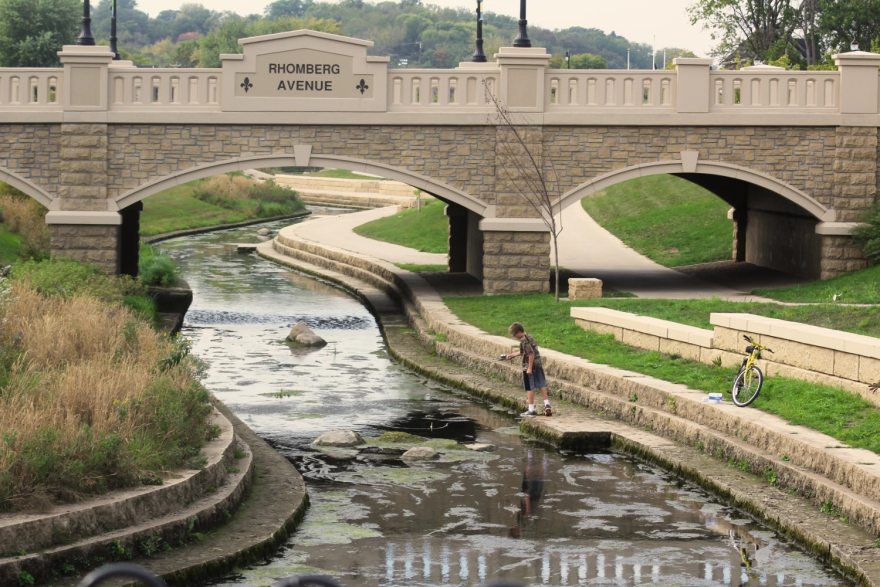  A child fishes in the Bee Branch Creek in Dubuque, Iowa, in 2017. The creek has become a place where people can interface and learn about watersheds.