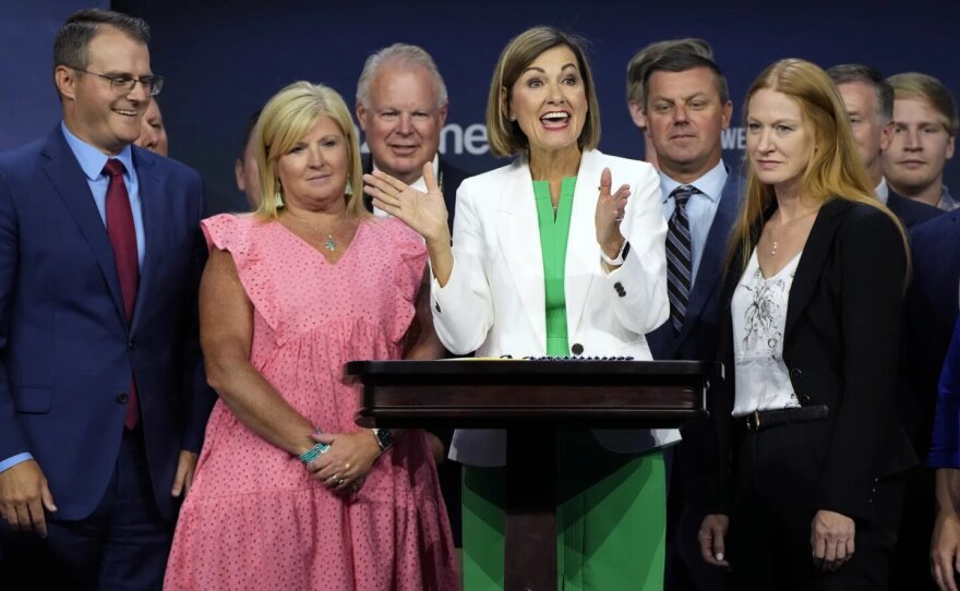  FILE - Iowa Gov. Kim Reynolds reacts after signing a new law banning abortions after six weeks of pregnancy before speaking at the Family Leadership Summit, Friday, Ju