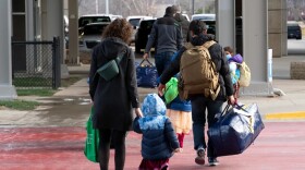 LSI team members accompany an Afghan family arriving at the Des Moines International Airport in December 2021.