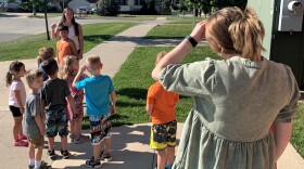 Jordan Lee (left) keeps count of the children in her class at Postville Child Care Services ahead of a walk around the block.