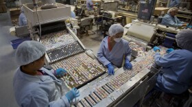 Workers sort NECCO Wafers at the New England Confectionery Co. in Revere, Mass. The Ohio-based Spangler Candy Company made the winning bid for NECCO, which filed for bankruptcy in early April.