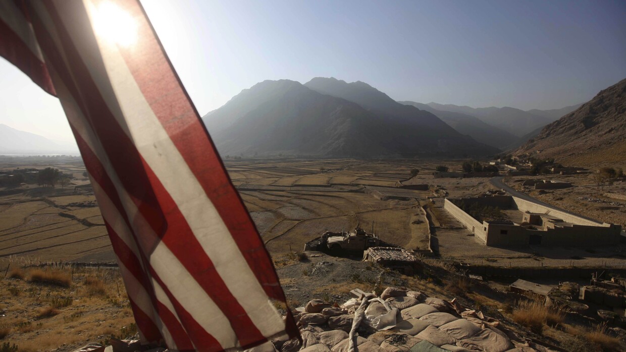 An American flag can be seen as 2nd Platoon Bravo Company 2-327 Infantry guards on the top of a vehicle Combat Out Post Badel in Kunar province in the eastern Afghanistan, Saturday, Dec 18, 2010.(AP Photo/Rafiq Maqbool)