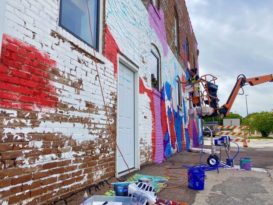 Artist David Manzanares paints his mural. The end design will be a portrayal of a local Hispanic dance troupe.