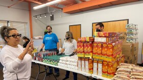 Zuli Garcia, founder of Knock and Drop Iowa, makes sure the food is organized for the walk through pantry on Thursday, Sept. 7. The walk-through food pantry with food trucks outside celebrated Hispanic Heritage Month and Garcia's nonprofit being awarded a national grant to continue its efforts in feeding Iowa's Latinos.