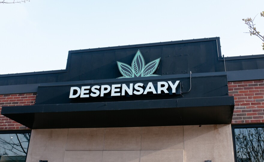 Store front reading "dispensary." 