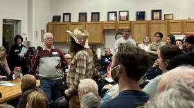 Johnson County Supervisor Jon Green reads his resolution to censure the County Attorney to a meeting of the Johnson County Democratic Party