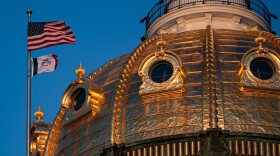 The U.S. and Iowa flag flying from Iowa's Capitol building.