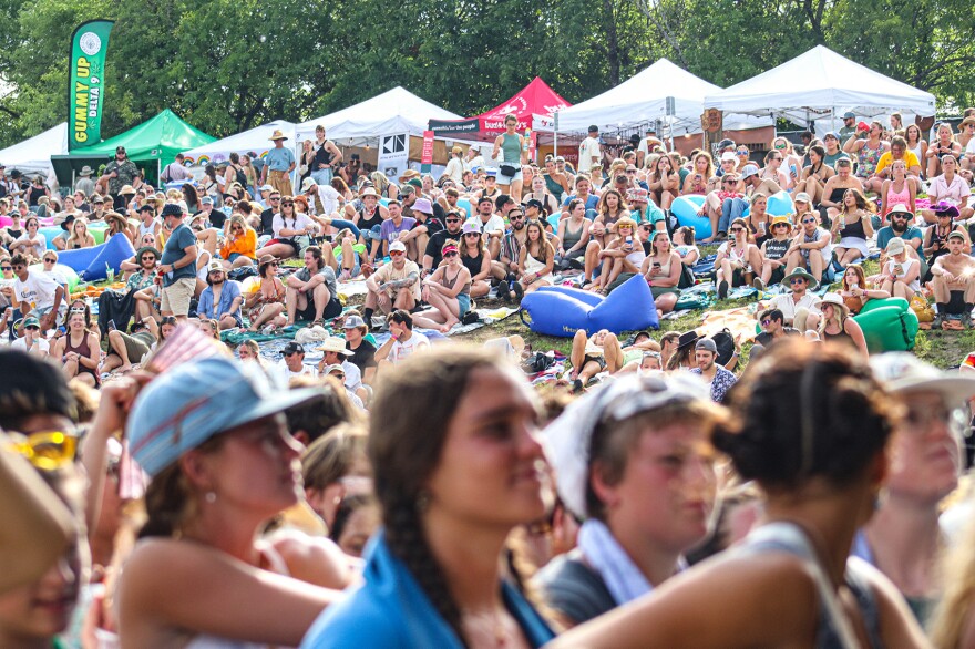 A crowd of people sit look at the stage at Hinterland Music Festival. 