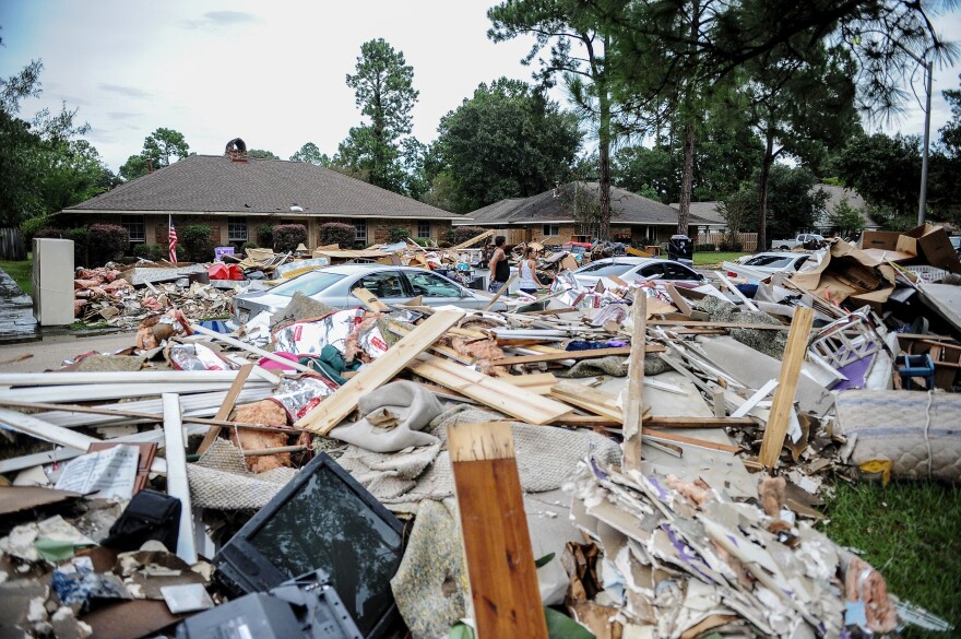 Climate-driven disasters are getting more frequent. They can be particularly destabilizing for college-age people who are in socially and financially formative years. Here, debris piled outside a home after a massive flood in Baton Rouge, La., in 2016.