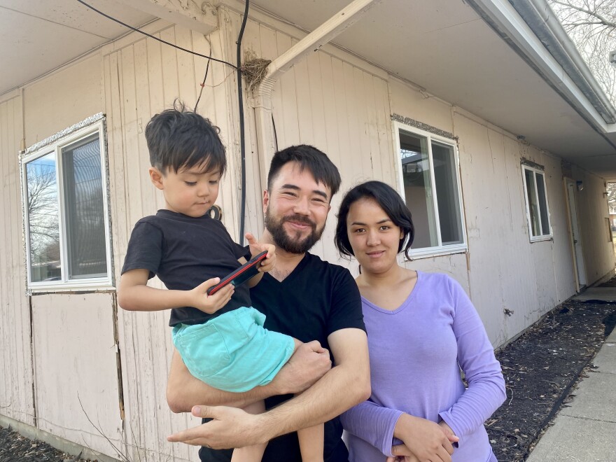  Reza Akrami and Firuza Haidari stand outside their new home in Sergeant Bluff with their child. 