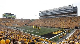 Fans cheer before an NCAA college football game between Iowa and North Texas at Kinnick Stadium.