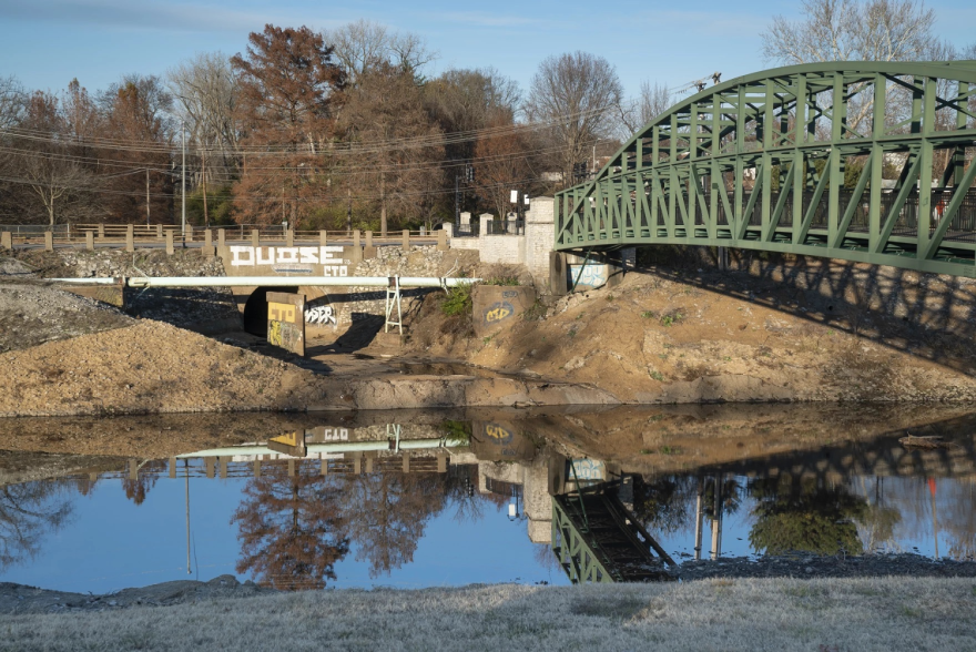 A thin layer of water lines the bottom of the River Des Peres near a storm sewer outlet and pedestrian bridge on Dec. 3 in south St. Louis. The river serves as a drainage channel for the city and frequently has debris and other trash in it.