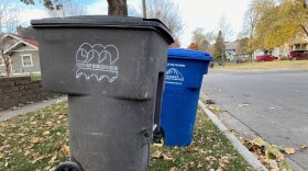 garbage and recycling bins on a curb