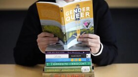 FILE - A pile of challenged books appear at the Utah Pride Center in Salt Lake City on Dec. 16, 2021. Attempted book bannings and restrictions at school and public libraries continue to surge, according to a new report from the American Library Association.