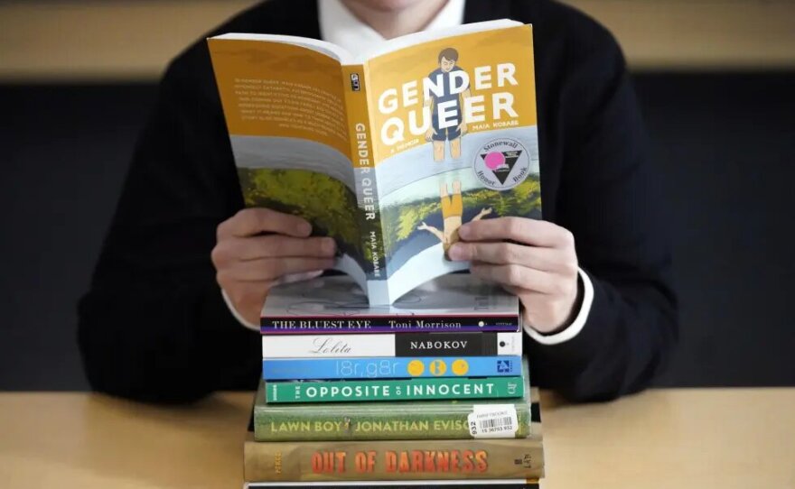 FILE - A pile of challenged books appear at the Utah Pride Center in Salt Lake City on Dec. 16, 2021. Attempted book bannings and restrictions at school and public libraries continue to surge, according to a new report from the American Library Association.