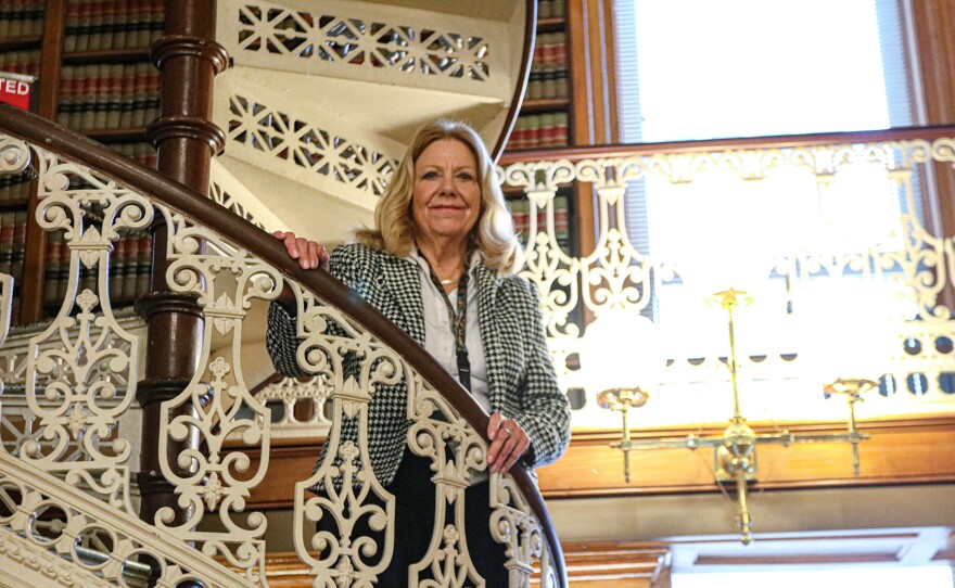 pam jochum stands in the law library at the iowa capitol